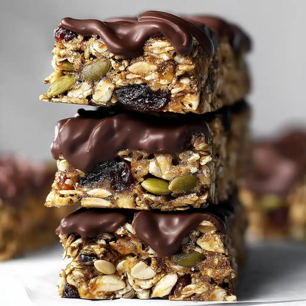 Stacked healthy flapjack bars with dark chocolate drizzle and seeds